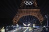 Floriane Issert, a Gendarmerie non-commissioned officer of the National Gendarmerie, rides on a horse while leading volunteers carrying flags of Olympic teams on the Iena Bridge in Paris, France, during the opening ceremony of the 2024 Summer Olympics, Friday, July 26, 2024. (Ludovic Marin/Pool Photo via AP)