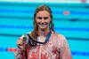 Summer McIntosh, of Canada, smiles as she holds her silver medal after the women's 400-meter freestyle final at the 2024 Summer Olympics, Saturday, July 27, 2024, in Nanterre, France. THE CANADIAN PRESS/Adrian Wyld