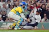 Boston Red Sox catcher Connor Wong, left, tags New York Yankees' Juan Soto trying to score on a double by Aaron Judge during the eighth inning of a baseball game, Saturday, July 27, 2024, in Boston. (AP Photo/Michael Dwyer)