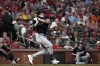 Washington Nationals' Jesse Winker hits an RBI single during the third inning of a baseball game against the St. Louis Cardinals Saturday, July 27, 2024, in St. Louis. (AP Photo/Jeff Roberson)