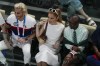Ariana Grande is flanked by RuPaul and Frankie Grande during a women's artistic gymnastics qualification round at the 2024 Summer Olympics, Sunday, July 28, 2024, in Paris, France. (AP Photo/Morry Gash)