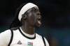 Nuni Omot, of South Sudan, celebrates after scoring in a men's basketball game against Puerto Rico at the 2024 Summer Olympics, Sunday, July 28, 2024, in Villeneuve-d'Ascq, France. (AP Photo/Michael Conroy)