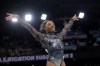 Simone Biles, of United States, smiles after competing on the vault during a women's artistic gymnastics qualification round at Bercy Arena at the 2024 Summer Olympics, Sunday, July 28, 2024, in Paris, France. (AP Photo/Charlie Riedel)