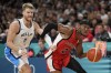 Shai Gilgeous-Alexander, of Canada, drives past Thomas Walkup, of Greece, in a men's basketball game at the 2024 Summer Olympics, Saturday, July 27, 2024 in Villeneuve-d'Ascq, France. THE CANADIAN PRESS/AP/Mark J. Terrill