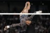 Simone Biles, of United States, competes on the uneven bars during a women's artistic gymnastics qualification round at Bercy Arena at the 2024 Summer Olympics, Sunday, July 28, 2024, in Paris, France. (AP Photo/Abbie Parr)