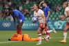Canada's Jessie Fleming holds the ball as she celebrates after scoring her side's opening goal during the women's Group A soccer match between Canada and France at Geoffroy-Guichard stadium during the 2024 Summer Olympics, Sunday, July 28, 2024, in Saint-Etienne, France. THE CANADIAN PRESS/AP-Silvia Izquierdo