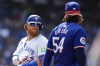 Toronto Blue Jays' Justin Turner exchanges words with Texas Rangers pitcher Jose Urena at the end of second inning American League MLB baseball action in Toronto on July 27, 2024. THE CANADIAN PRESS/Chris Young