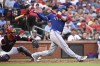 Texas Rangers' Jonah Heim, right, watches his RBI single next to St. Louis Cardinals catcher Willson Contreras in the fourth inning of a baseball game, Monday, July 29, 2024, in St. Louis. (AP Photo/Joe Puetz)
