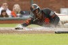 San Francisco Giants designated hitter Jorge Soler (2) scores sliding to home plate against Colorado Rockies catcher Elias Díaz (35) after a triple by the Giants' Mike Yastrzemski (5) in the first inning during the second baseball game of a doubleheader in San Francisco, Saturday, July 27, 2024. (Santiago Mejia/San Francisco Chronicle via AP)