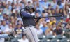 Miami Marlins' Josh Bell watches his double during the second inning of a baseball game against the Milwaukee Brewers, Saturday, July 27, 2024, in Milwaukee. (AP Photo/Jeffrey Phelps)