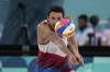 US' Miles Evans reaches the ball during the men's pool F beach volleyball match between Netherlands and USA at Eiffel Tower Stadium at the 2024 Summer Olympics, Tuesday, July 30, 2024, in Paris, France. (AP Photo/Louise Delmotte)