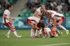 Canada's players celebrate after Vanessa Gilles, bottom centre, scored her side's second goal during the women's Group A soccer match between Canada and France at Geoffroy-Guichard stadium during the 2024 Summer Olympics, Sunday, July 28, 2024, in Saint-Etienne, France. THE CANADIAN PRESS/AP/Silvia Izquierdo