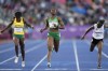 FILE - Favour Ofili of Nigeria, centre crosses the finish line ahed of Natalliah Whyte of Jamaica, left, and Gina Bass of The Gambia, right, in a Women's 200 meters semifinal during the athletics competition in the Alexander Stadium at the Commonwealth Games in Birmingham, England, Friday, Aug. 5, 2022. Nigeria's national champion in the women's 100-meter sprint won't run the race at the Olympics because she says her country's track federation didn't enter her into the field in time. (AP Photo/Manish Swarup, File)