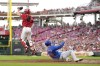 Chicago Cubs' Cody Bollinger (24) scores against Cincinnati Reds catcher Tyler Stephenson on a double hit by teammate Patrick Wisdom during the third inning of a baseball game, Wednesday, July 31, 2024, in Cincinnati. (AP Photo/Jeff Dean)