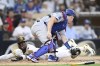 San Diego Padres' Jurickson Profar (10) scores ahead of the tag by Los Angeles Dodgers catcher Will Smith (16) during the fourth inning of a baseball game Tuesday, July 30, 2024, in San Diego. (AP Photo/Denis Poroy)