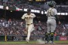 San Francisco Giants' Mike Yastrzemski, left, scores next to Oakland Athletics catcher Shea Langeliers on Brett Wisely's sacrifice fly during the fifth inning of a baseball game Wednesday, July 31, 2024, in San Francisco. (AP Photo/Godofredo A. Vásquez)