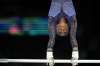 Simone Biles, of the United States, warms up on uneven bars during the women's artistic gymnastics all-around finals in Bercy Arena at the 2024 Summer Olympics, Thursday, Aug. 1, 2024, in Paris, France. (AP Photo/Natacha Pisarenko)