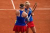 Barbora Krejcikov and Katerina Siniakova of Czech Republic talk during their match against Mirra Andreeva and Diana Shnaider of Individual Neutral Athlete compete against during their women's doubles quarter-final match at the Roland Garros stadium, at the 2024 Summer Olympics, Thursday, Aug. 1, 2024, in Paris, France. (AP Photo/Manu Fernandez)