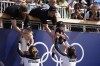New Zealand's Brooke Francis, left, hands off daughter Keira and Lucy Spoors hands off son Rupert after winning gold in the women's double sculls final at the 2024 Summer Olympics, Thursday, Aug. 1, 2024, in Vaires-sur-Marne, France. (AP Photo/Lindsey Wasson)