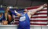 FILE - Joe Kovacs, of the United States, celebrates with his wife Ashley after winning gold in the men's shot put final at the World Athletics Championships in Doha, Qatar, Oct. 5, 2019. (AP Photo/David J. Phillip, File)