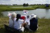 Korean fans watch Tom Kim, of South Korea, play the 15th Hoel during the second round of the men's golf event at the 2024 Summer Olympics, Friday, Aug. 2, 2024, at Le Golf National in Saint-Quentin-en-Yvelines, France. (AP Photo/Matt York)