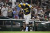 Milwaukee Brewers' William Contreras celebrates after his home run as he rounds the bases during the seventh inning of a baseball game against the Washington Nationals, Friday, Aug. 2, 2024, in Washington. (AP Photo/Nick Wass)