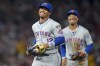 New York Mets shortstop Francisco Lindor, left, celebrates with third baseman Mark Vientos, after the final out of the fifth inning of a baseball game against the Los Angeles Angels, Friday, Aug. 2, 2024, in Anaheim, Calif. (AP Photo/Ryan Sun)