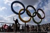 The public lines up to have their picture taken with the Olympic rings in front of the Louvre museum at the 2024 Summer Olympics, Thursday, Aug. 1, 2024, in Paris, France. (AP Photo/David Goldman)