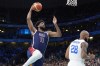 United States' Joel Embiid, left, goes up for a dunk as Puerto Rico's Ismael Romero defends during a men's basketball game at the 2024 Summer Olympics, Saturday, Aug. 3, 2024, in Villeneuve-d'Ascq, France. (AP Photo/Michael Conroy)