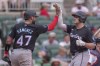 Miami Marlins' Jake Burger, right, high-fives teammate Ali Sánchez, left, as he tags home plate after hitting a three-run home run in the fourth inning of a baseball game against the Atlanta Braves, Sunday, Aug. 4, 2024, in Atlanta. (AP Photo/Jason Allen)