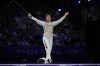 Japan's Kazuki Iimura celebrates after winning the men's team foil final match against Italy during the 2024 Summer Olympics at the Grand Palais, Sunday, Aug. 4, 2024, in Paris, France. (AP Photo/Andrew Medichini)