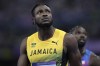 Kishane Thompson, of Jamaica, and Noah Lyles, of the United States, in the background, wait for the official results after finishing the men's 100 meters final at the 2024 Summer Olympics, Sunday, Aug. 4, 2024, in Saint-Denis, France. Lyles won, Thompson was second and Kerley third. (AP Photo/Ashley Landis)