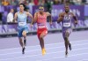 Canada's Andre De Grasse, centre, of Markham, Ont., competes in the men’s 200m qualifying heat at the 2024 Summer Olympics, Monday, Aug. 5, 2024, in Saint-Denis, France. The 29-year-old crossed the finish line in 20.30 seconds to finish second in Heat 6. THE CANADIAN PRESS/Christinne Muschi