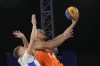Worthy de Jong (54) of the Netherlands, shoots the ball past Timothe Vergiat, left, of France, during a men's 3x3 basketball gold medal game during the 2024 Summer Olympics, Monday, Aug. 5, 2024, in Paris, France. (AP Photo/Frank Franklin II)