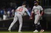 Minnesota Twins' Royce Lewis, left, and Manuel Margot, right, celebrate after their win over the Chicago Cubs in a baseball game Monday, Aug. 5, 2024, in Chicago. (AP Photo/Erin Hooley)