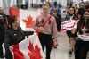 Canadian Olympic Swimmer Summer McIntosh is greeted by family members and fans after arriving at Toronto Pearson International Airport in Mississauga, Ont., Tuesday, Aug. 6, 2024. After landing back in Toronto, Summer McIntosh says she will return to Paris if selected as Canada's flag bearer for the closing ceremony. THE CANADIAN PRESS/Arlyn McAdorey