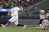 Toronto Blue Jays' Alejandro Kirk hits a three-run home run as Baltimore Orioles catcher Adley Rutschman looks on during sixth inning MLB baseball action in Toronto on Tuesday, August 6, 2024. THE CANADIAN PRESS/Chris Young