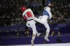 Palestine's Omar Yaser Ismail, right, competes with Refugees Olympic Team's Hadi Tiranvalipour in a men's 58kg Taekwondo match during the 2024 Summer Olympics, at the Grand Palais, Wednesday, Aug. 7, 2024, in Paris, France. (AP Photo/Andrew Medichini)