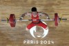 Li Fabin of China competes during the men's 61kg weightlifting event at the 2024 Summer Olympics, Wednesday, Aug. 7, 2024, in Paris, France. (AP Photo/Dita Alangkara,Pool)
