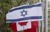 The flags of Canada and Israel fly at half mast at a community building on Wednesday, Oct. 11, 2023 in Ottawa. THE CANADIAN PRESS/Adrian Wyld
