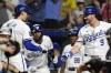 Kansas City Royals' Bobby Witt Jr., left, is congratulated by Kansas City Royals' Vinnie Pasquantino (9) after hitting a solo home run during the sixth inning of a baseball game against the Boston Red Sox, Wednesday, Aug. 7, 2024, in Kansas City, Mo. (AP Photo/Reed Hoffmann)