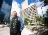 MIKAELA MACKENZIE / FREE PRESS
                                David Chartrand, president of the Manitoba Métis Federation, stands in front of the MMF&rsquo;s planned property acquisition &mdash; the two Bell MTS-branded towers (and a parking lot) downtown.