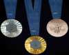The Paris 2024 Olympic medals are pictured at the Paris Olympic organizers in Saint-Denis, outside Paris, Thursday, Feb. 8, 2024. A hexagonal, polished piece of iron taken from the iconic Eiffel Tower landmark is being embedded in each gold, silver and bronze medal that will be hung around athletes' necks at the July 26-Aug. 11 Paris Games and Paralympics that follow. (AP Photo/Thibault Camus)