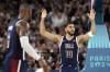 United States' Jayson Tatum, right, celebrates after dunking as United States' LeBron James watches during a men's basketball game against Brazil at the 2024 Summer Olympics, Tuesday, Aug. 6, 2024, in Paris, France. (AP Photo/Michael Conroy)