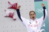 Gold medallist Aleksandra Miroslaw of Poland celebrates on the podium after winnin the women's speed final during the sport climbing competition at the 2024 Summer Olympics, Wednesday, Aug. 7, 2024, in Le Bourget, France. (AP Photo/Tsvangirayi Mukwazhi)