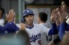 Los Angeles Dodgers' Freddie Freeman (5) celebrates with teammates after scoring a run during the first inning of a baseball game against Philadelphia Phillies in Los Angeles, Wednesday, Aug. 7, 2024. (AP Photo/Eric Thayer)