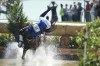 Ecuador's Ronald Zabala G., riding, Forever Young Wundermaske, fall off their horse during the Equestrian Cross Country competition at Chateau de Versailles for the 2024 Summer Olympics, Sunday, July 28, 2024, in Versailles, France. (AP Photo/Mosa'ab Elshamy)