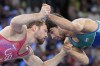 Spencer Richard Lee, of the United State, left, and Uzbekistan's Gulomjon Abdullaev compete in their men's freestyle 57kg semifinal wrestling match, at Champ-de-Mars Arena, during the 2024 Summer Olympics, Thursday, Aug. 8, 2024, in Paris, France. (AP Photo/Eugene Hoshiko)