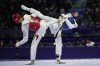 Uzbekistan's Ulugbek Rashitov competes with Jordan's Zaid Kareem in a men's 68kg Taekwondo final match during the 2024 Summer Olympics, at the Grand Palais, Thursday, Aug. 8, 2024, in Paris, France. (AP Photo/Andrew Medichini)