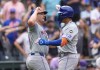 New York Mets' Pete Alonso, left, congratulates Mark Vientos, right, after Vientos' two-run home run off Colorado Rockies relief pitcher Peter Lambert in the fifth inning of a baseball game Thursday, Aug. 8, 2024, in Denver. (AP Photo/David Zalubowski)